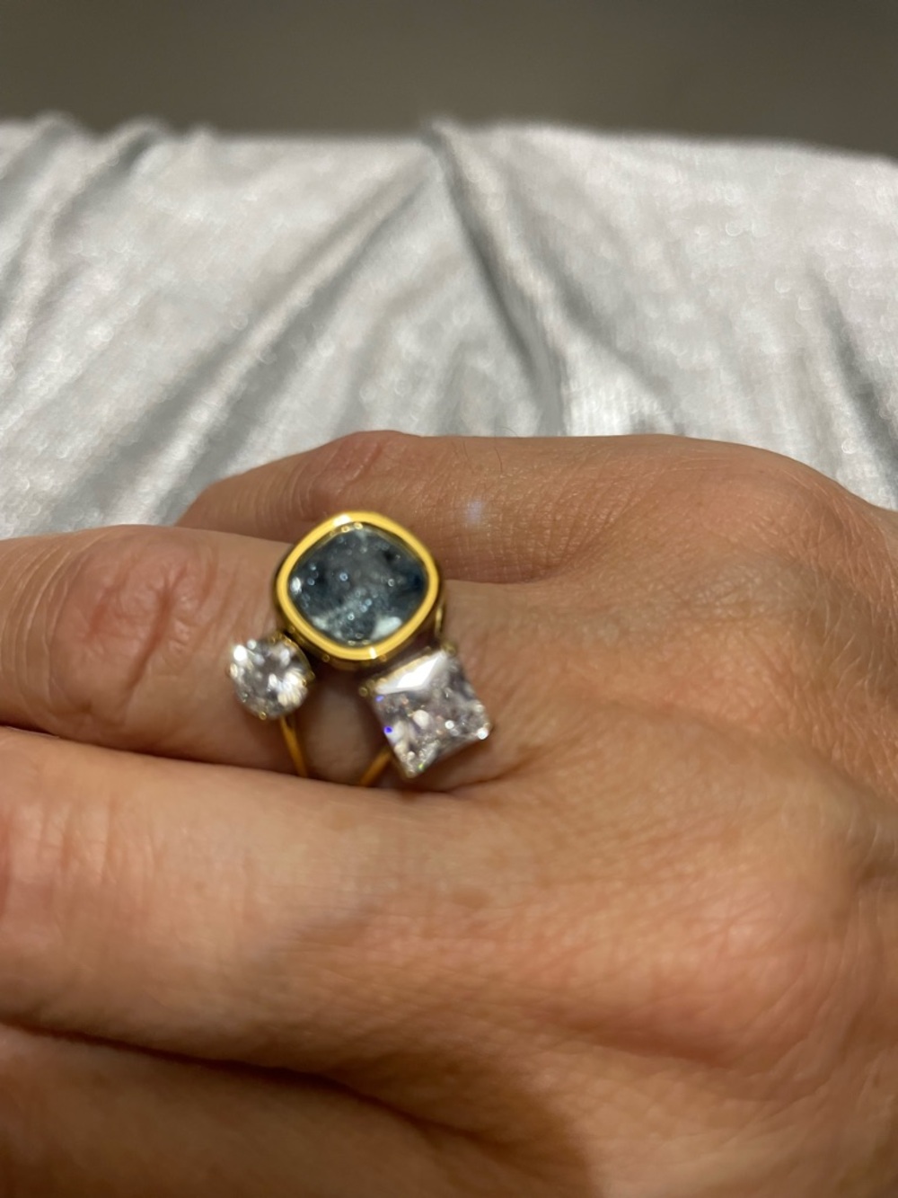 Gold Ring with Blue Oval Gem and Clear Cubic Stones